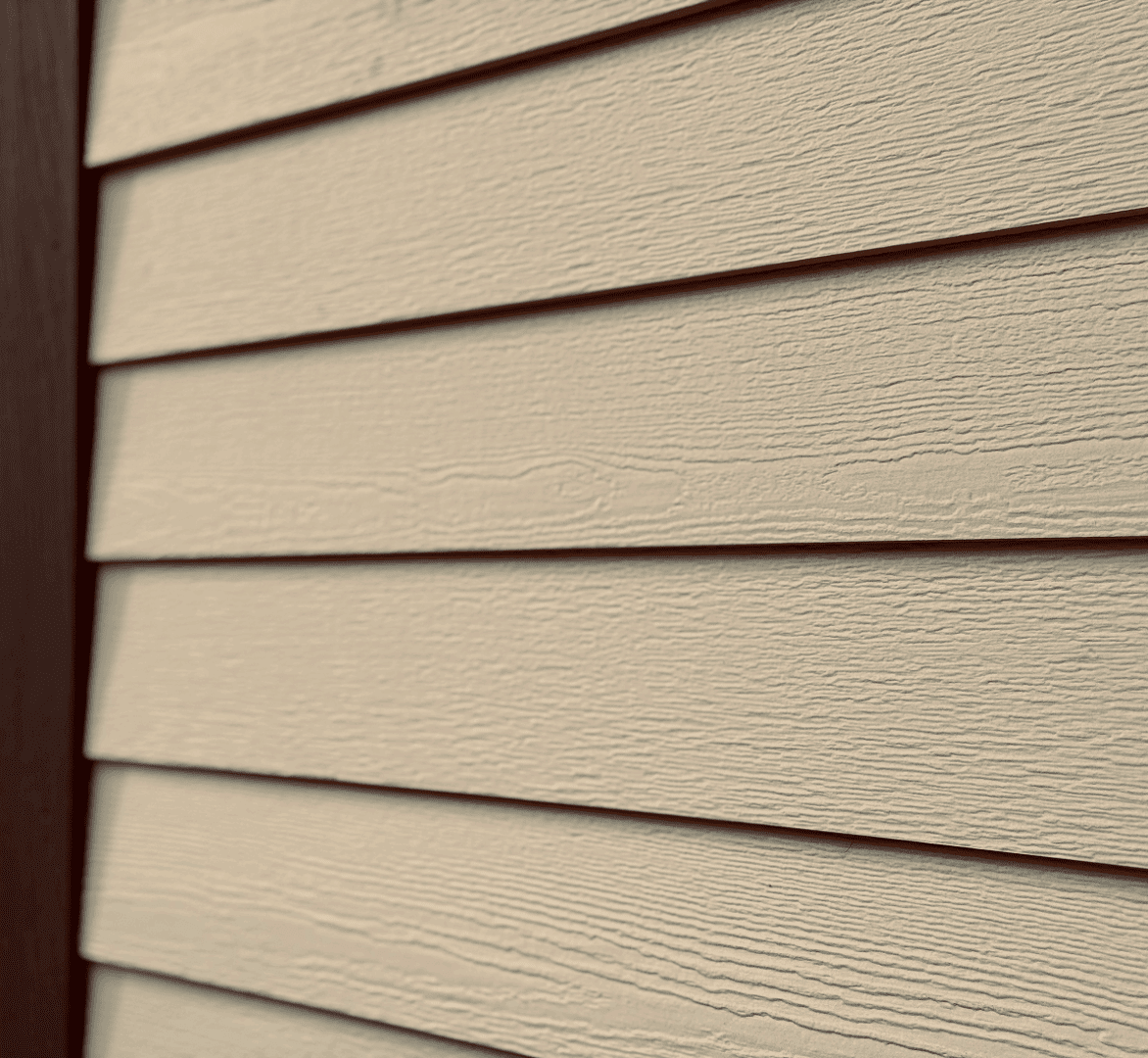 Beige horizontal wood siding on house exterior.